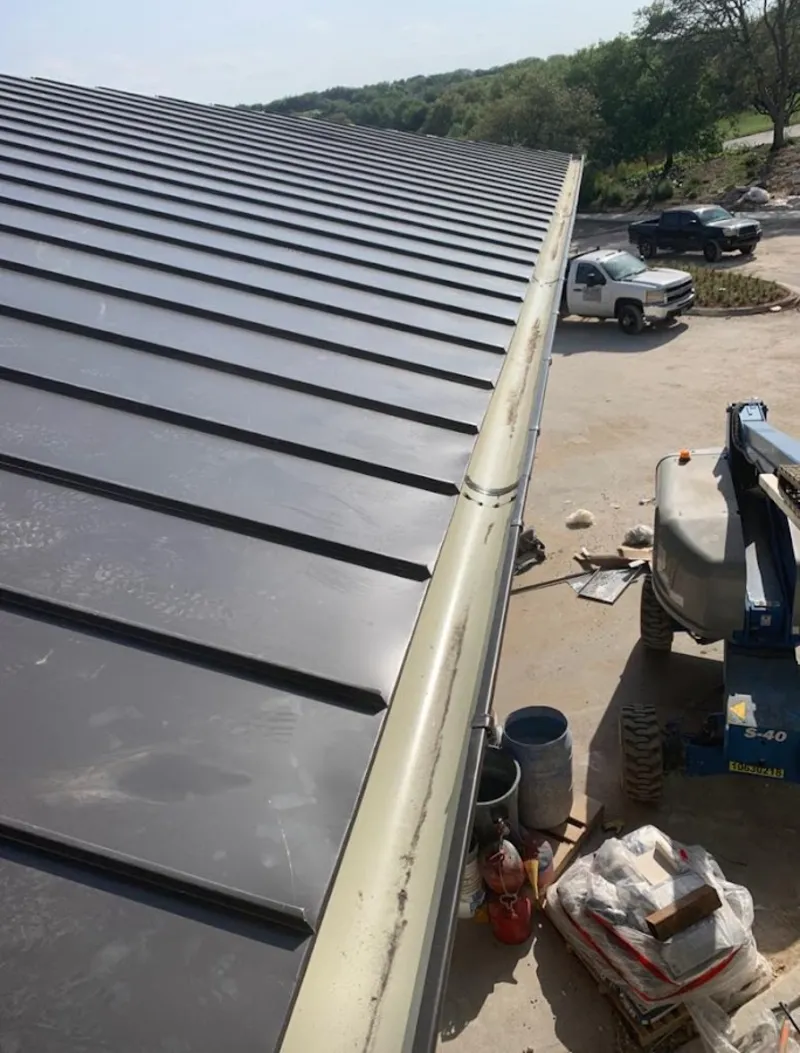 Standing seam panel and gutter detail on a metal roofing jobsite in Oregon City